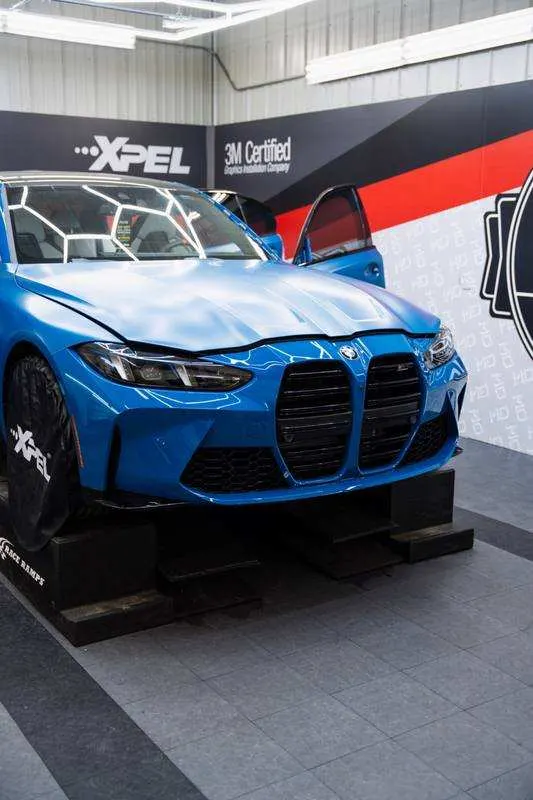 XPEL paint protection film install on a blue BMW